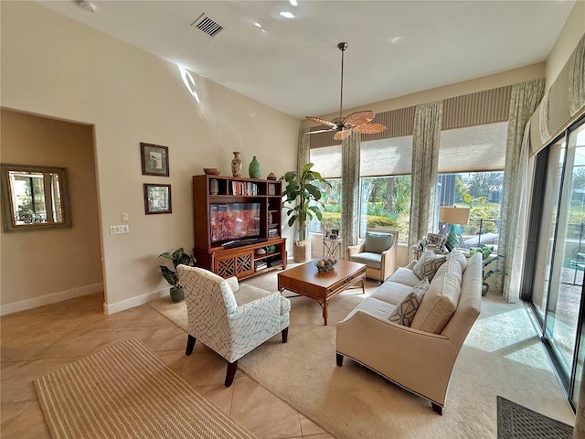 living room with a ceiling fan, light tile patterned flooring, visible vents, and baseboards