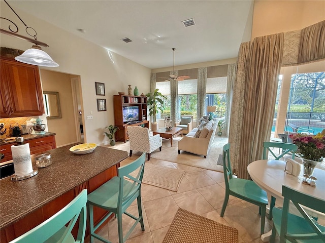 dining room with light tile patterned floors, visible vents, and a ceiling fan