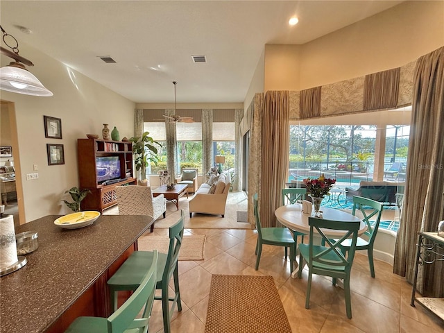 dining area with light tile patterned floors and visible vents