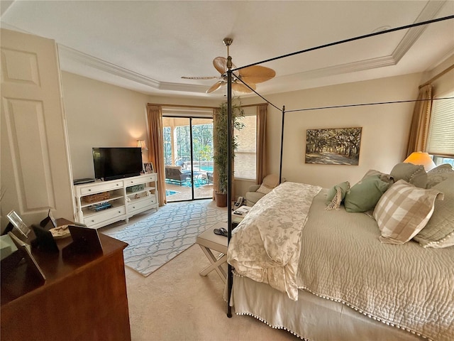 bedroom featuring a raised ceiling, a ceiling fan, ornamental molding, access to exterior, and carpet