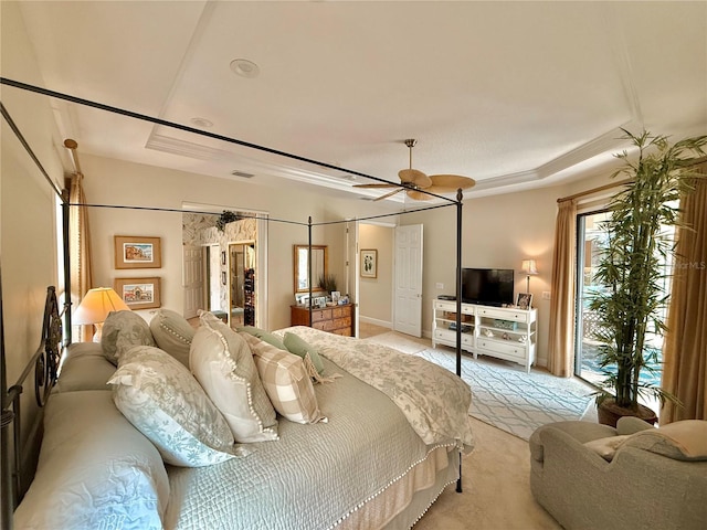 bedroom featuring a tray ceiling and a ceiling fan