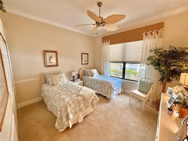 carpeted bedroom featuring ceiling fan, ornamental molding, and baseboards