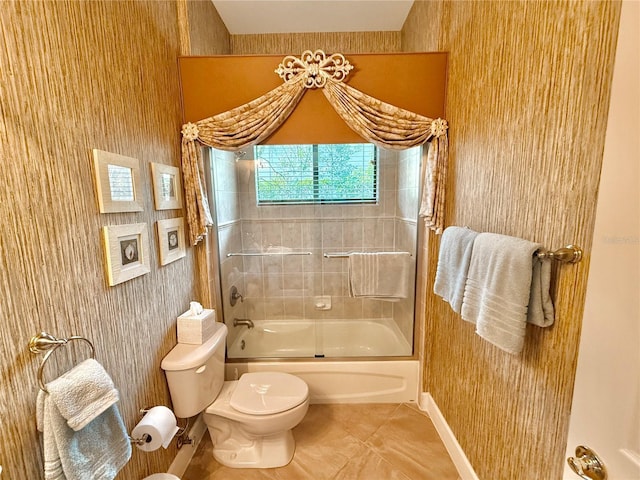 bathroom with toilet, shower / bath combination with glass door, and tile patterned flooring