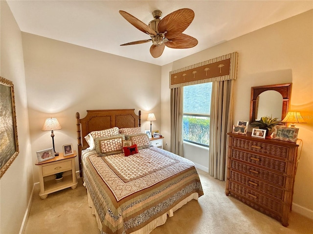 bedroom featuring ceiling fan, baseboards, and light colored carpet