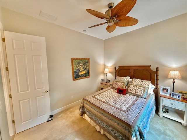 bedroom featuring a ceiling fan, light colored carpet, and baseboards