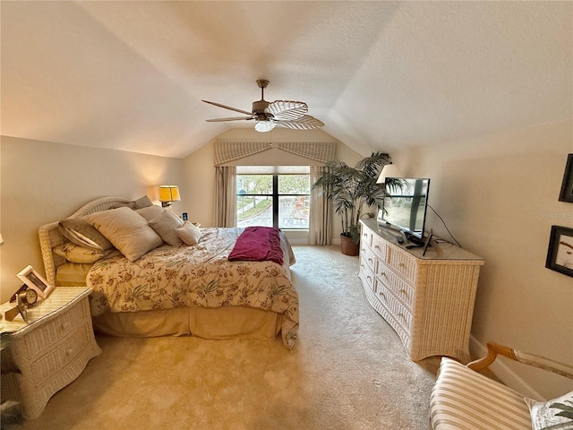 carpeted bedroom featuring lofted ceiling, ceiling fan, and a textured ceiling