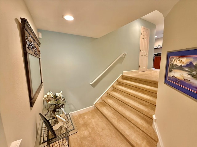 stairway with carpet flooring and baseboards