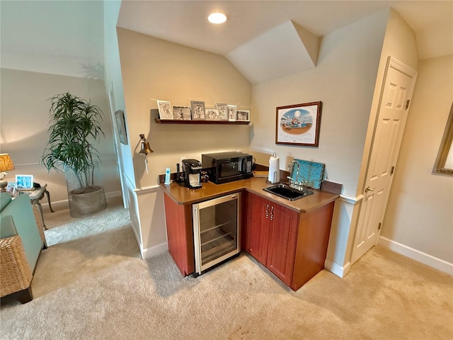 office with light carpet, beverage cooler, baseboards, vaulted ceiling, and a sink