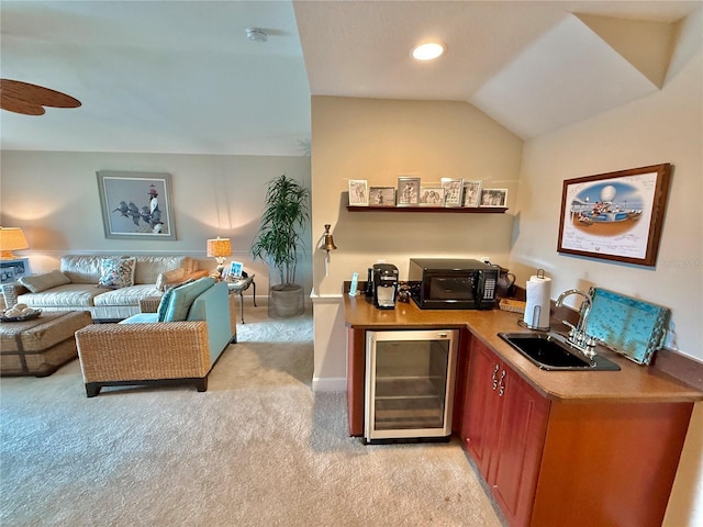 office area with beverage cooler, light colored carpet, lofted ceiling, a sink, and indoor wet bar