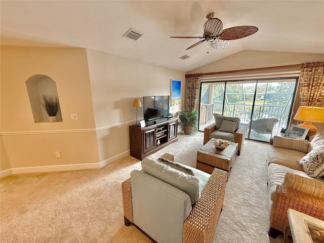 living room featuring light colored carpet, visible vents, a ceiling fan, vaulted ceiling, and baseboards