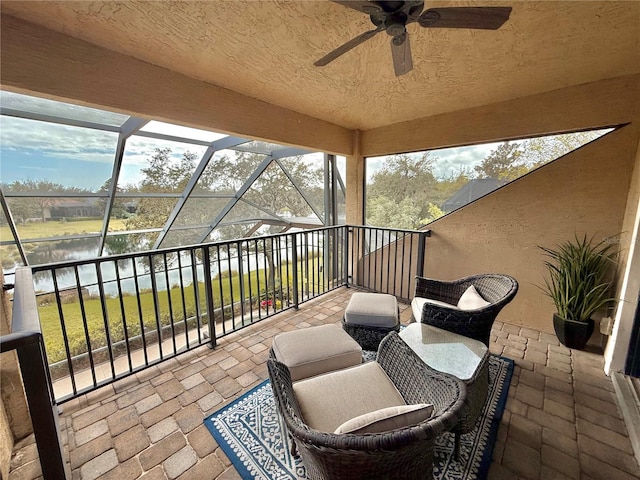 view of patio / terrace featuring glass enclosure and ceiling fan