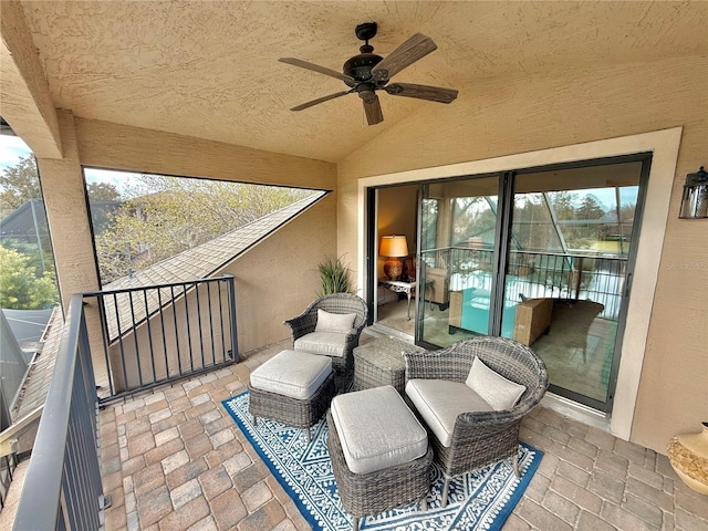 view of patio / terrace with ceiling fan and a balcony