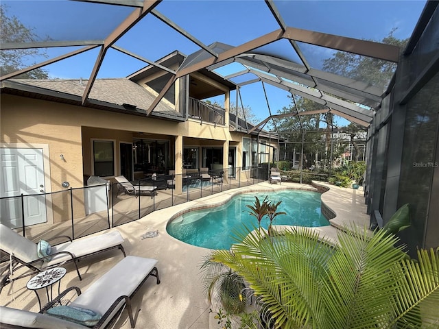 outdoor pool with a patio area