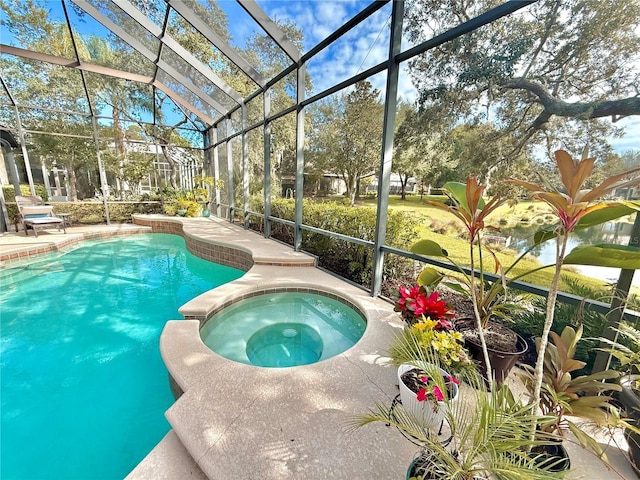 view of swimming pool featuring a lanai, a pool with connected hot tub, and a patio