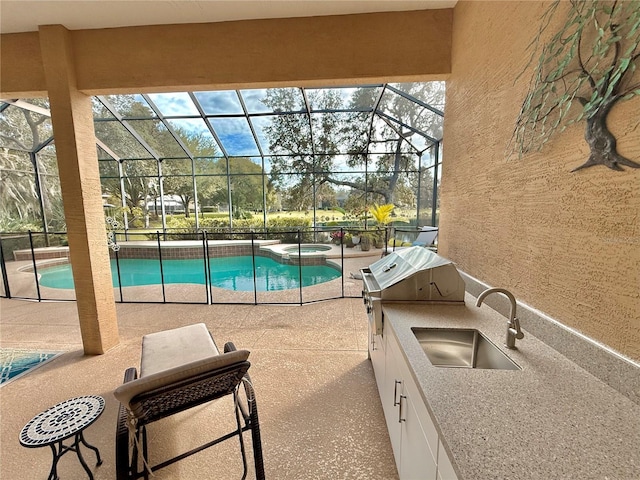 view of swimming pool with a patio, exterior kitchen, a sink, and a lanai