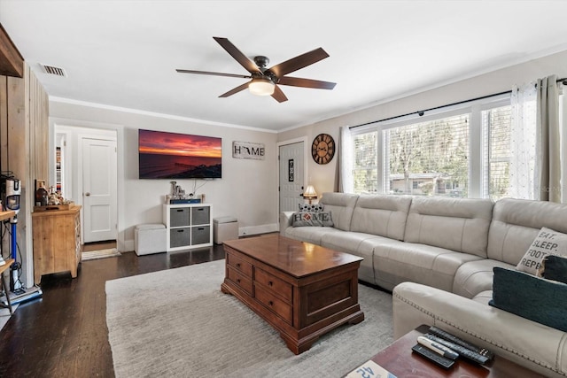 living room featuring dark wood-type flooring, visible vents, crown molding, and ceiling fan