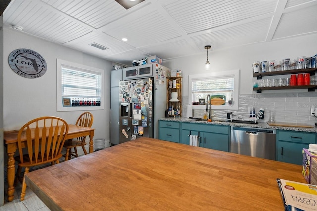 kitchen with visible vents, decorative backsplash, butcher block countertops, appliances with stainless steel finishes, and a sink