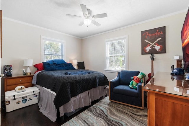 bedroom featuring a ceiling fan, multiple windows, crown molding, and wood finished floors