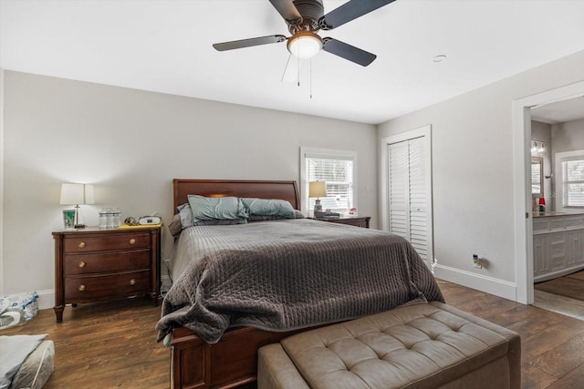 bedroom with ensuite bathroom, a closet, wood finished floors, and baseboards