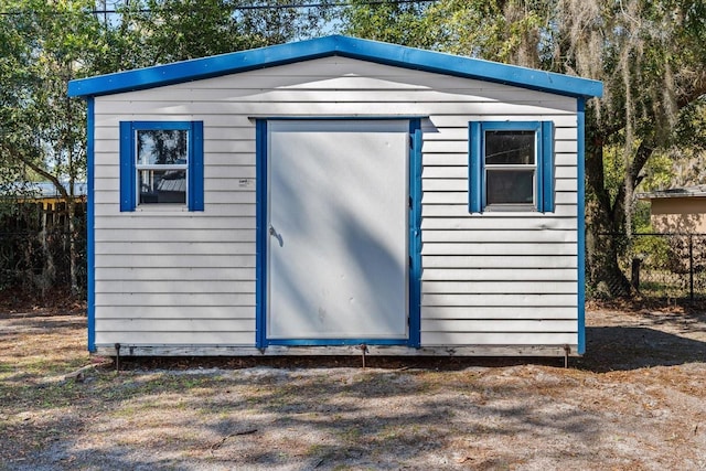 view of shed featuring fence