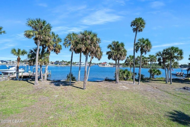 dock area featuring a yard and a water view