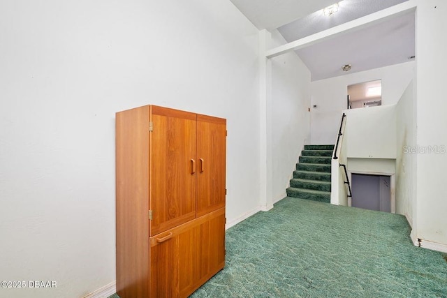 staircase with carpet floors and baseboards