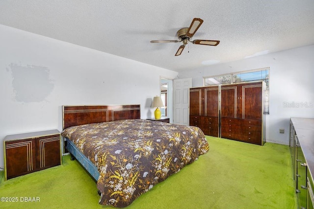 bedroom with a textured ceiling, ceiling fan, and light colored carpet