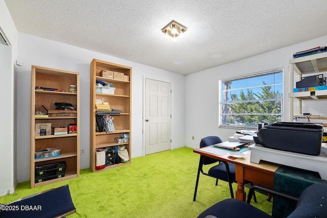 home office with a textured ceiling and carpet flooring