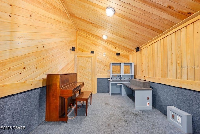 interior space with wooden ceiling, vaulted ceiling, carpet flooring, and wood walls