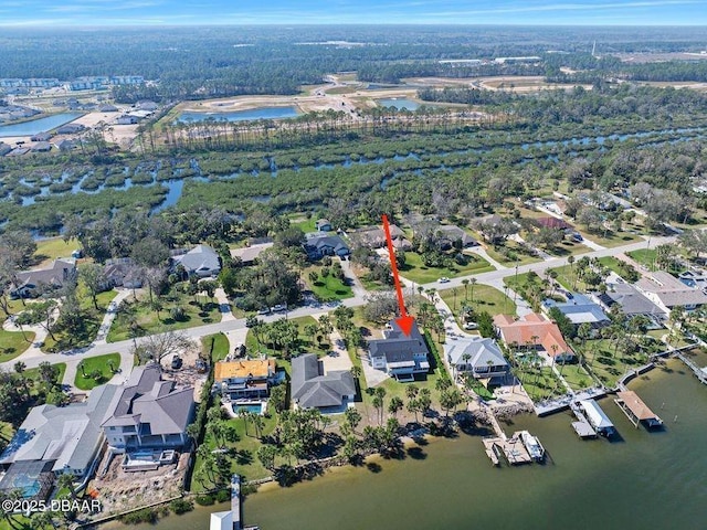 drone / aerial view featuring a water view and a residential view