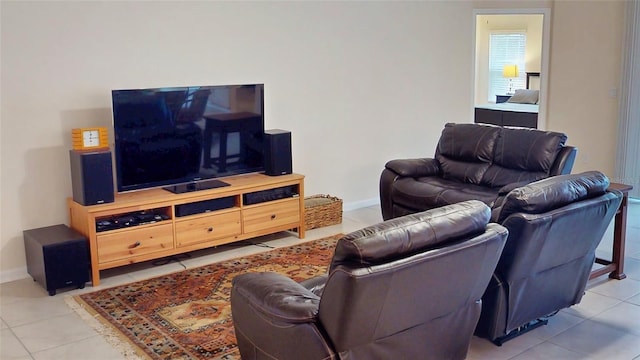 living area featuring light tile patterned floors and baseboards