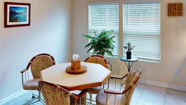 dining room featuring light tile patterned flooring and baseboards