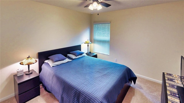 carpeted bedroom featuring ceiling fan and baseboards