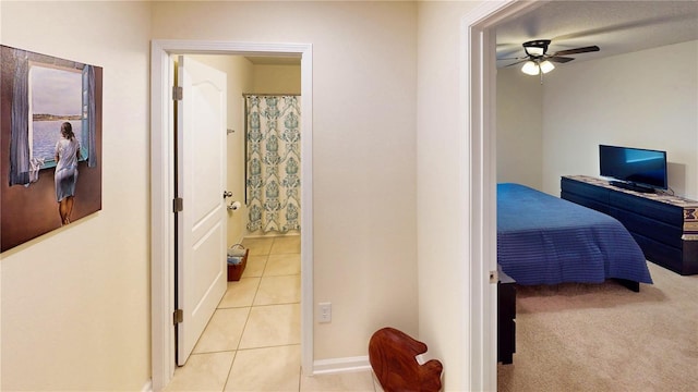 interior space with ensuite bathroom and light tile patterned flooring