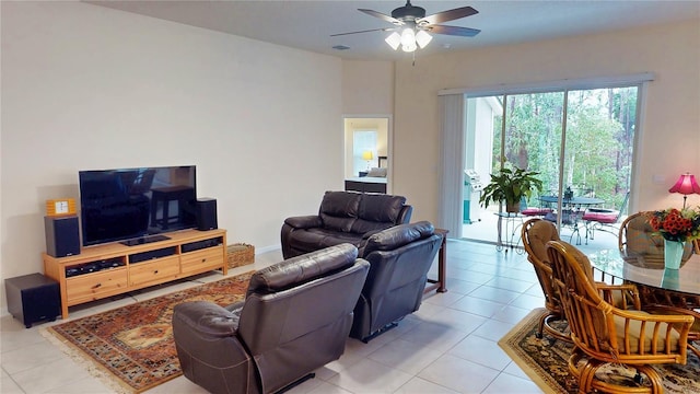 living room with light tile patterned floors, visible vents, and a ceiling fan