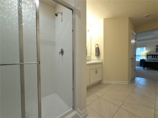 bathroom with a stall shower, ensuite bath, tile patterned floors, a textured ceiling, and vanity