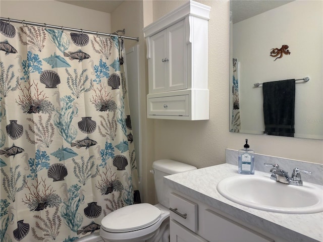 bathroom with curtained shower, vanity, and toilet