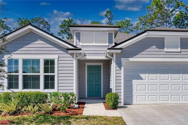 view of front of property featuring a garage and concrete driveway