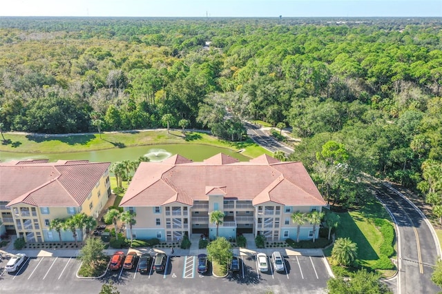 drone / aerial view with a wooded view