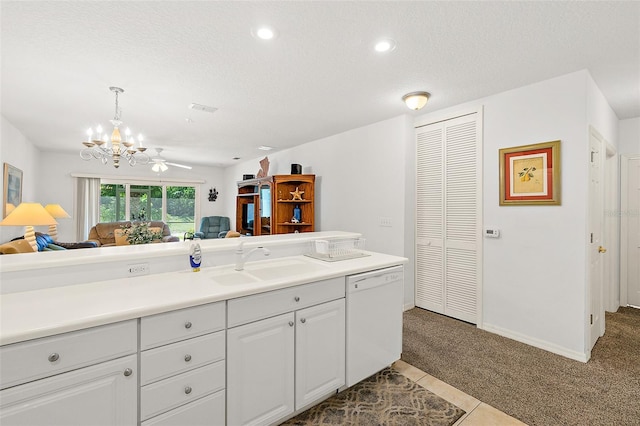 kitchen with dishwasher, carpet floors, a textured ceiling, and a sink