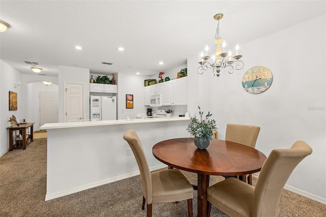 dining space featuring arched walkways, recessed lighting, light carpet, visible vents, and baseboards