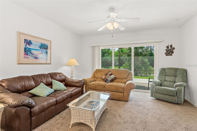 carpeted living room with ceiling fan