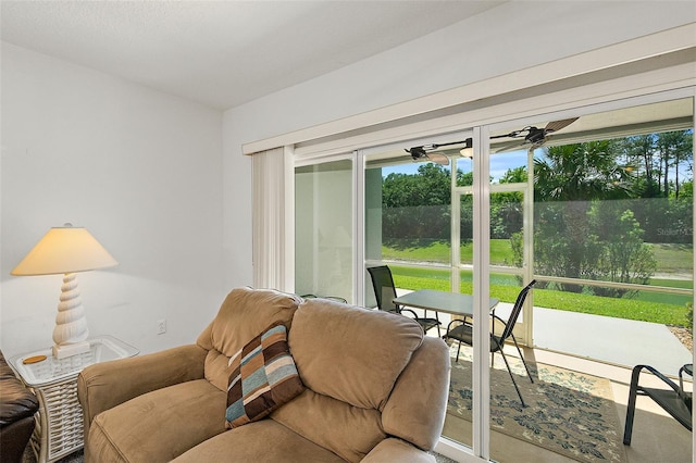 living area with a sunroom and ceiling fan