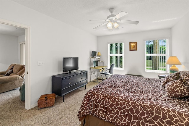 bedroom featuring carpet, ceiling fan, and a textured ceiling