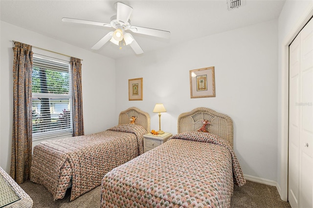 carpeted bedroom featuring baseboards, visible vents, ceiling fan, and a closet