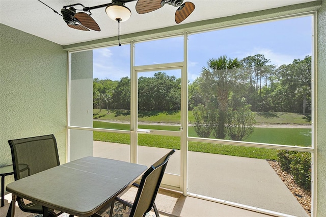 sunroom / solarium featuring a wealth of natural light and a ceiling fan