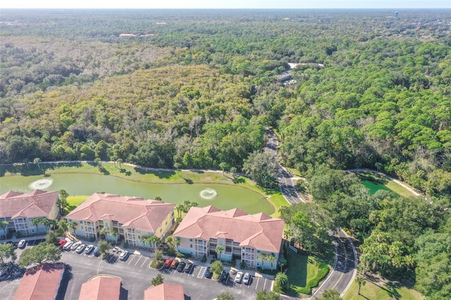 aerial view with a water view and a wooded view