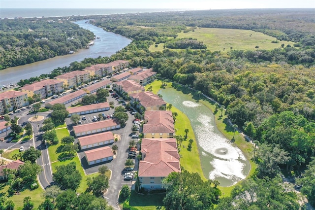 aerial view with a water view and a wooded view