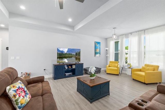 living room featuring light wood-style flooring, baseboards, and recessed lighting