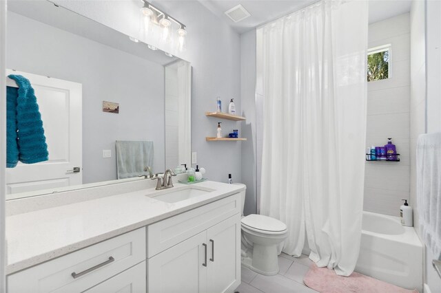 bathroom featuring tile patterned flooring, toilet, vanity, visible vents, and shower / bath combination with curtain